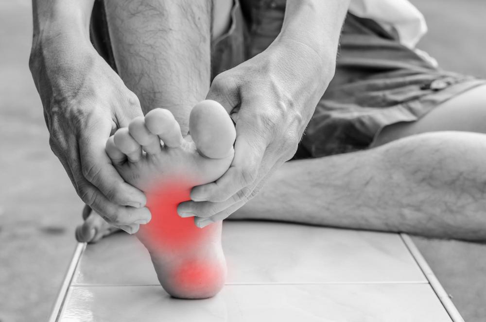 Man with foot pain seeking a chiropractor.