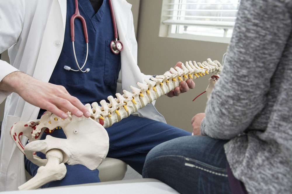 Doctor talking to his patient about chiropractic care.